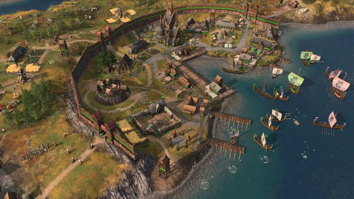 A Viking village with a wooden palisade and longships on the water in Age of Empires IV