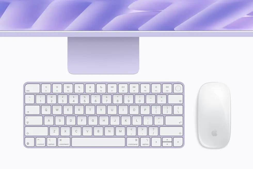 Purple iMac stand with a colour-matched Magic Keyboard and Magic Mouse