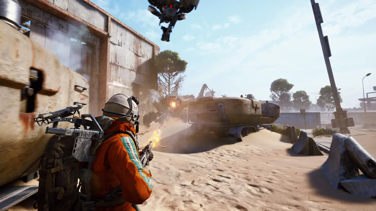 A raider in an orange suit fighting a machine in the desert