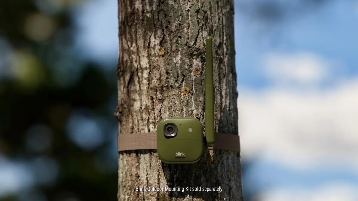 Green Blink Frontier XR+ trail camera strapped to a tree trunk