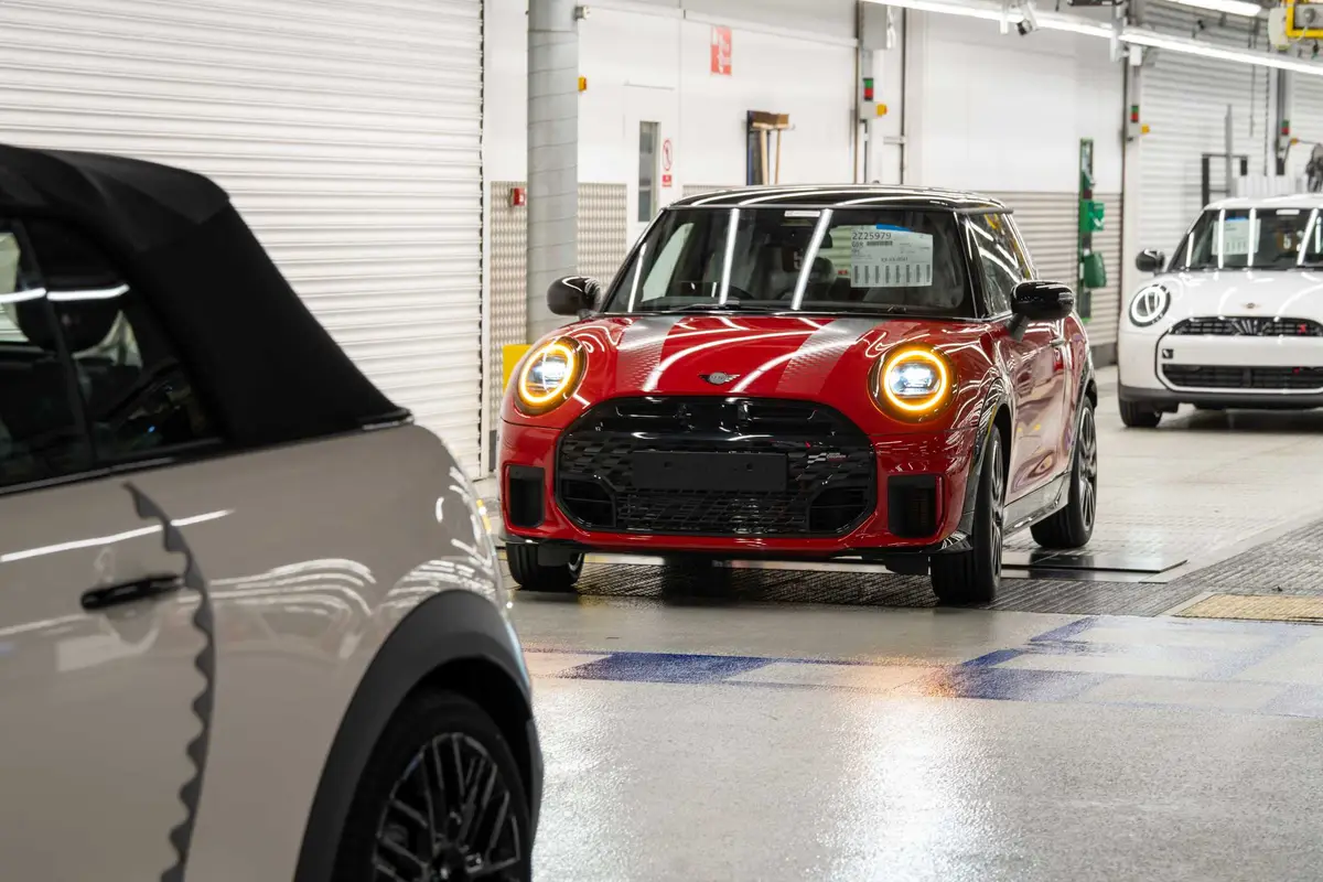Red MINI John Cooper Works driving itself along the line at MINI Plant Oxford