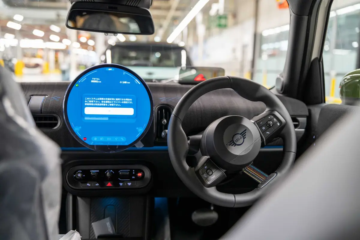 Driver's view inside a new MINI with no one at the wheel on the plant floor