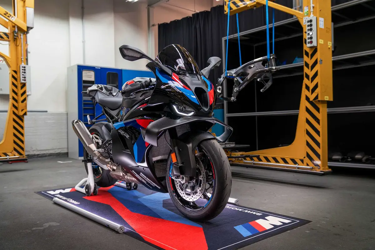 BMW M 1000 RR in a workshop next to its M Motorsport frame