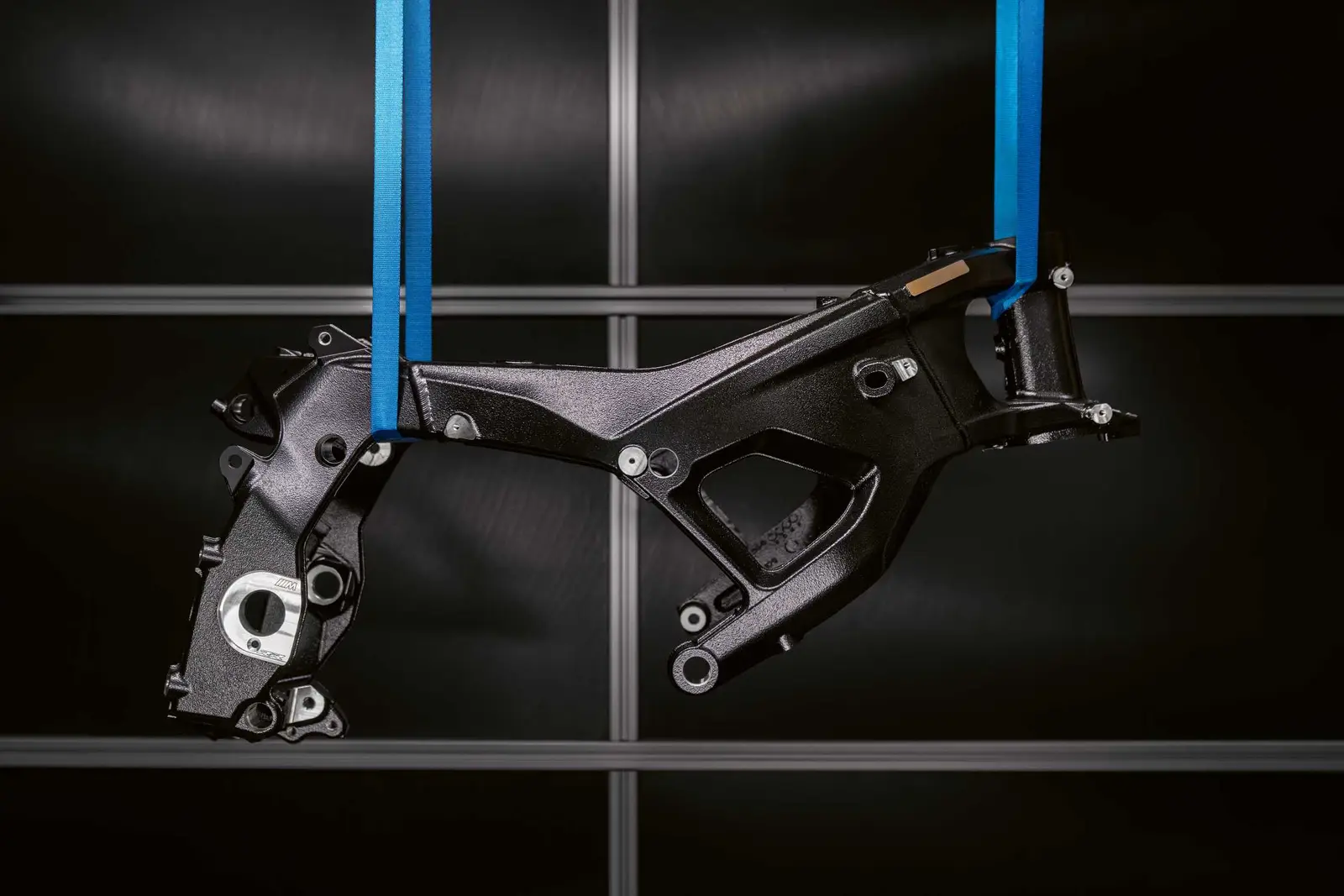 Black aluminium M Motorsport frame for the BMW M 1000 RR hanging on blue straps