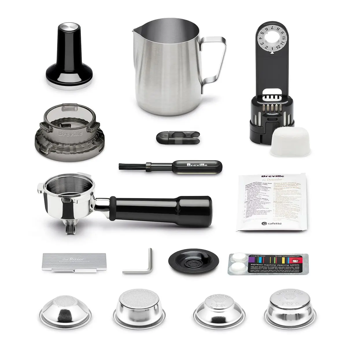 Barista Express accessories laid out including tamper, milk jug and filter baskets