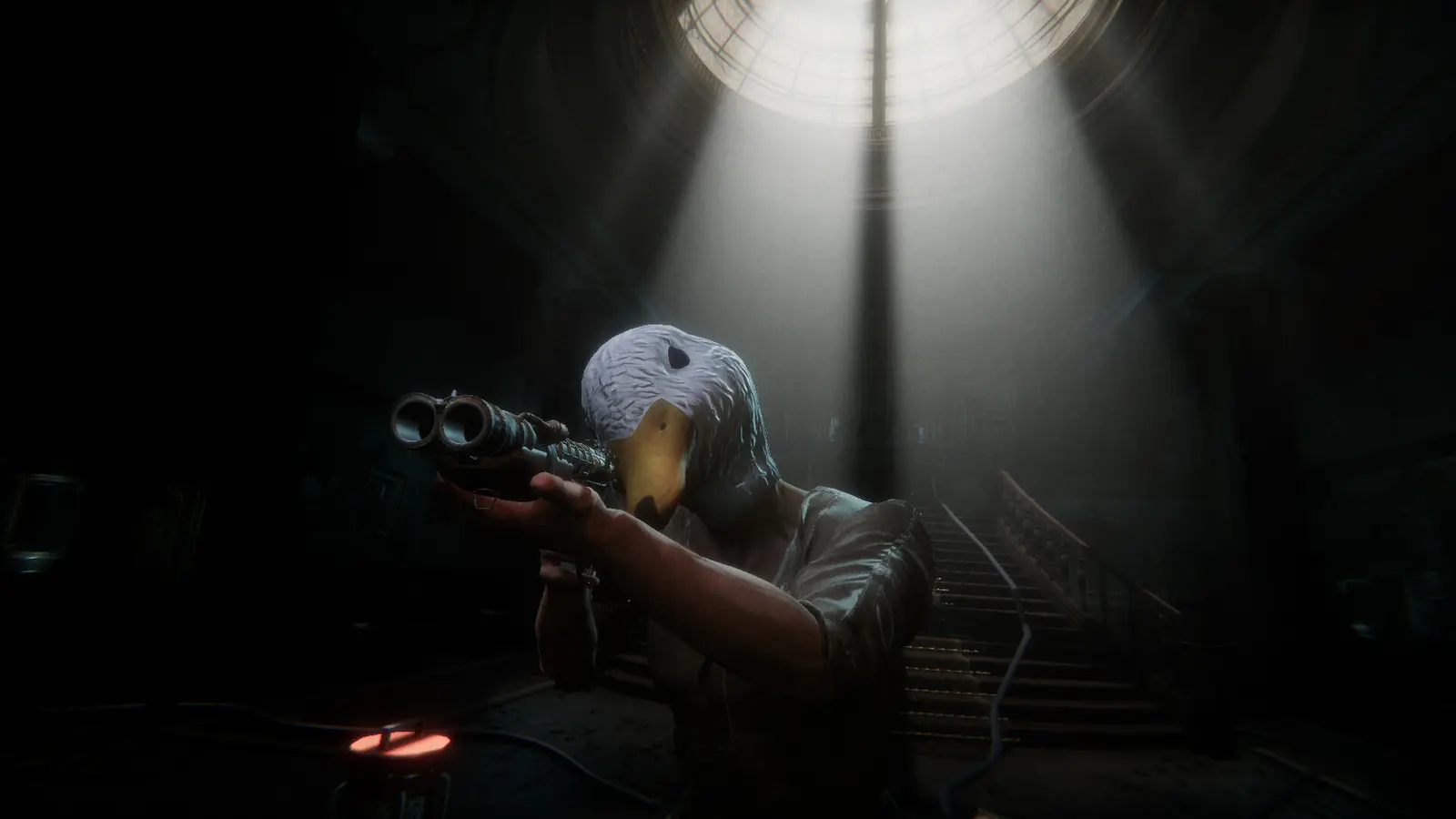Person playing a horror game on a gaming PC in a dark room