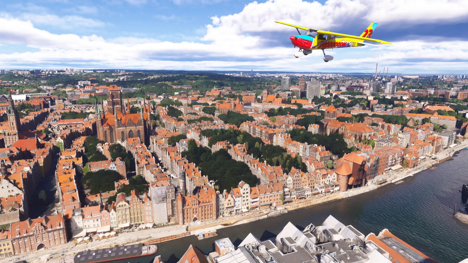 Small plane flying over the old town and river of Gdansk