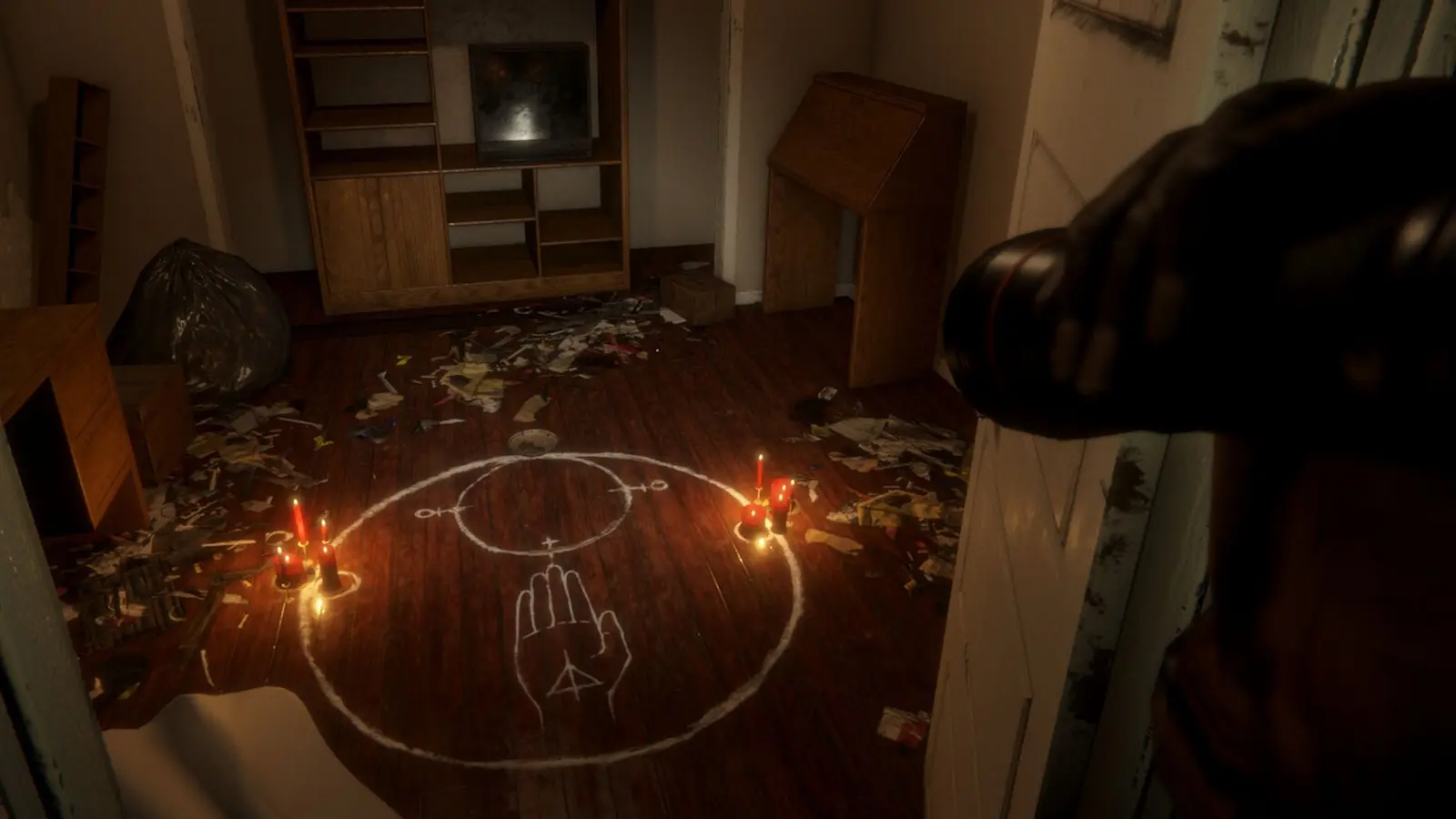 Dark room with candles and a chalk circle drawn on the floor in a horror game