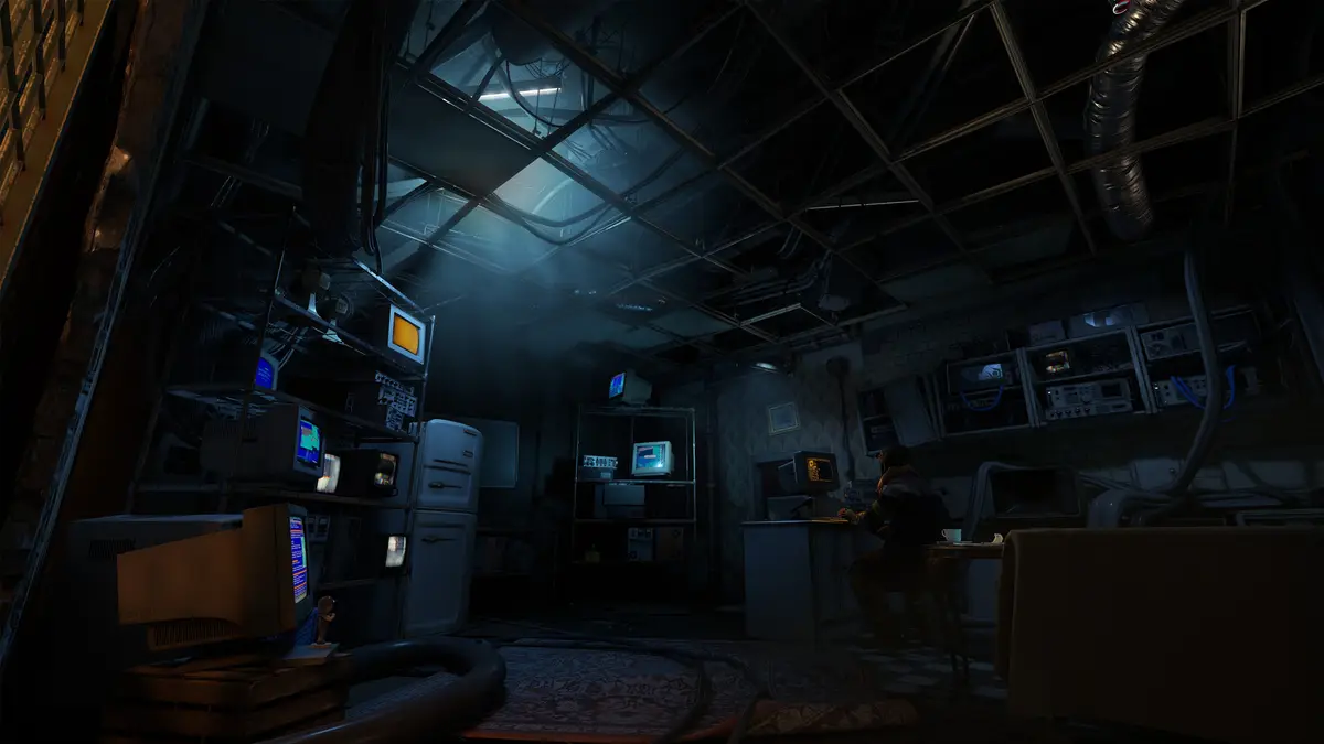 Screenshot of a dim blue lit room filled with monitors and equipment