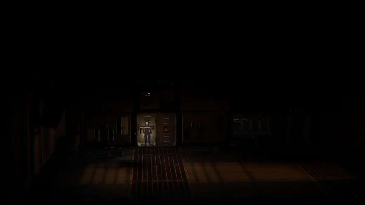 An explorer stands in a dim doorway inside a mining facility