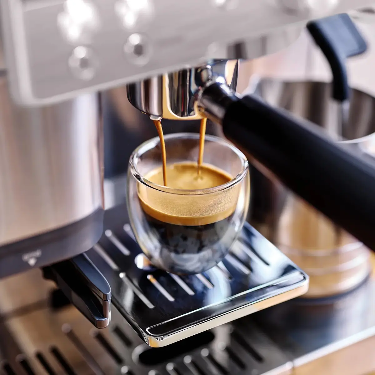 Espresso pouring into a glass from the Luxe Café portafilter