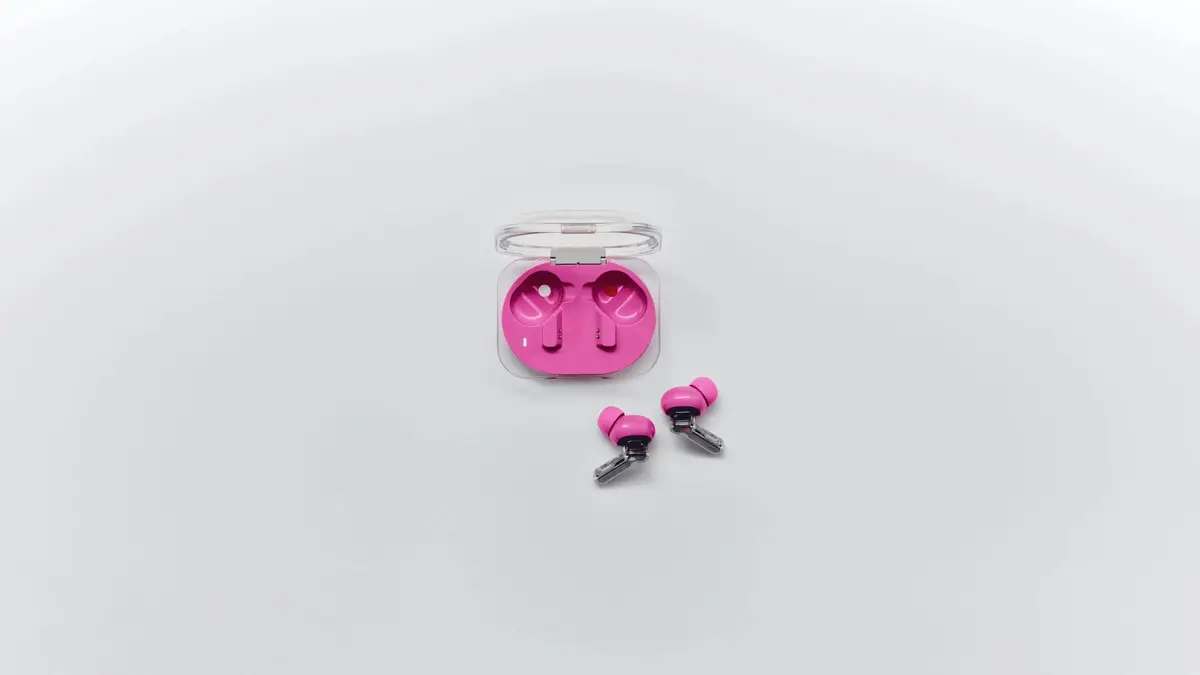 Pink Nothing Ear (3a) earbuds and case on a light surface