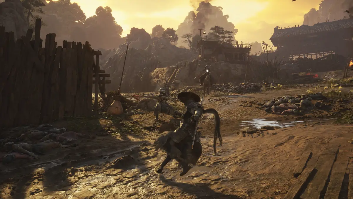 Straw-hatted warrior in a ruined village at sunset