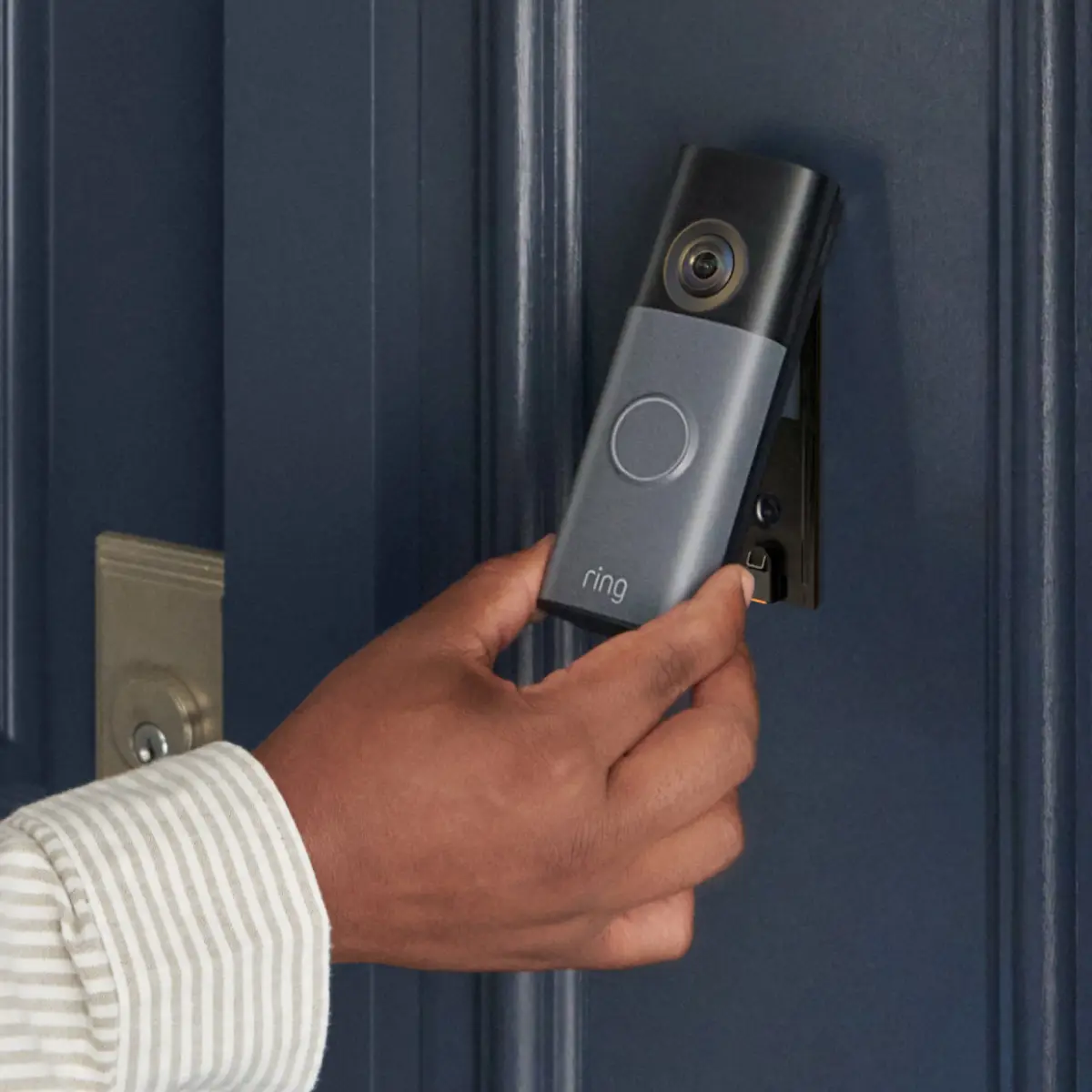 Hand mounting the Ring Battery Doorbell on a front door frame