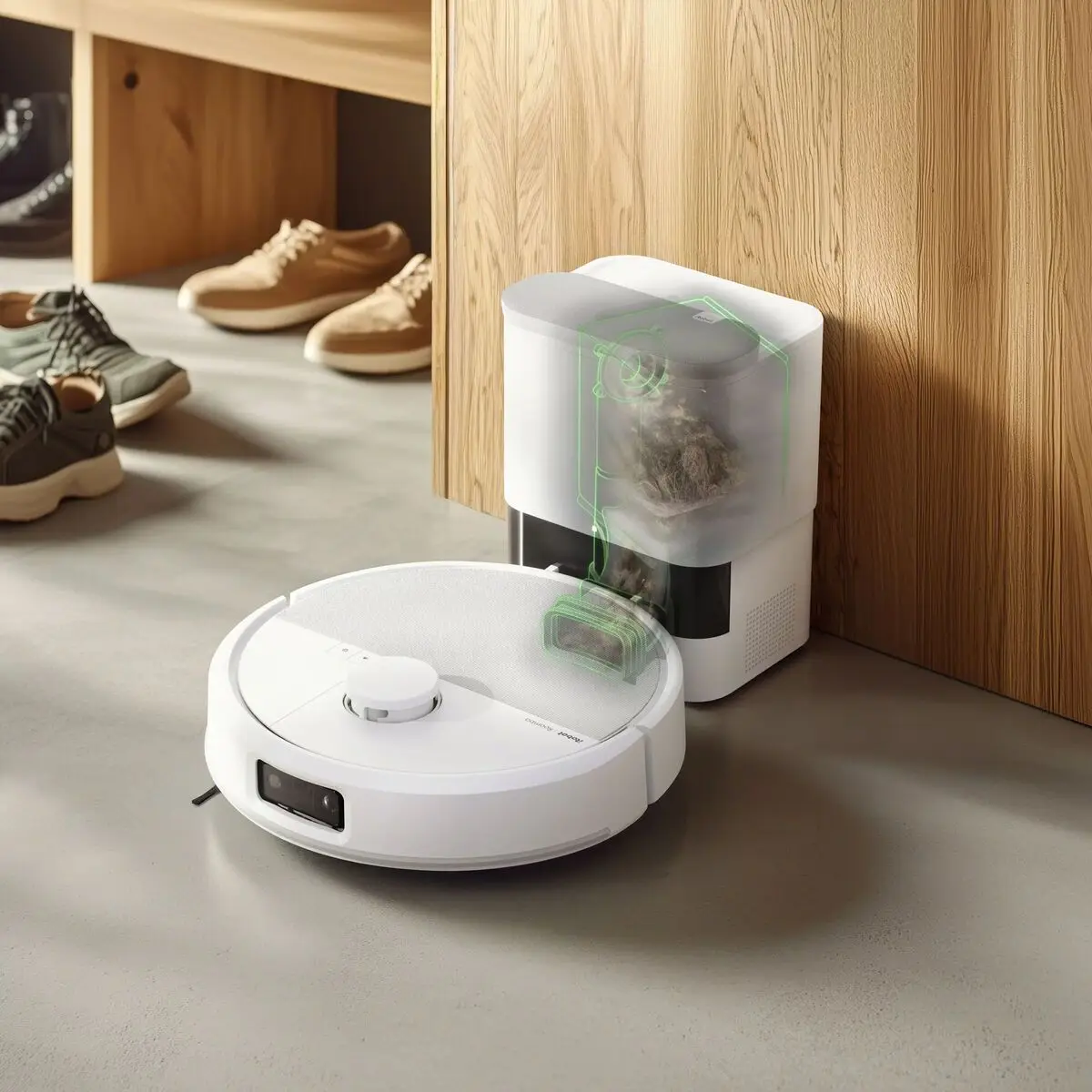 Roomba Max 715 Vac près de sa base AutoEmpty avec une coupe du sac à poussière