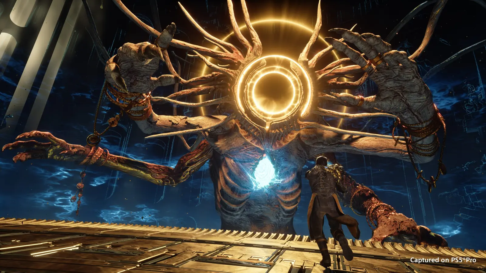 A lone figure faces a huge glowing boss towering over a metal platform in Saros, captured on PS5 Pro