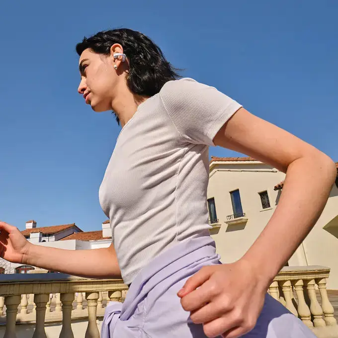 Person wearing the Shokz OpenDots Air clip-on earbuds