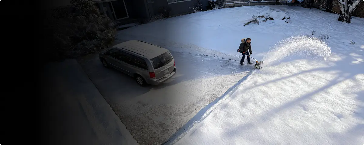 Aerial view of a driveway being cleared next to a parked van