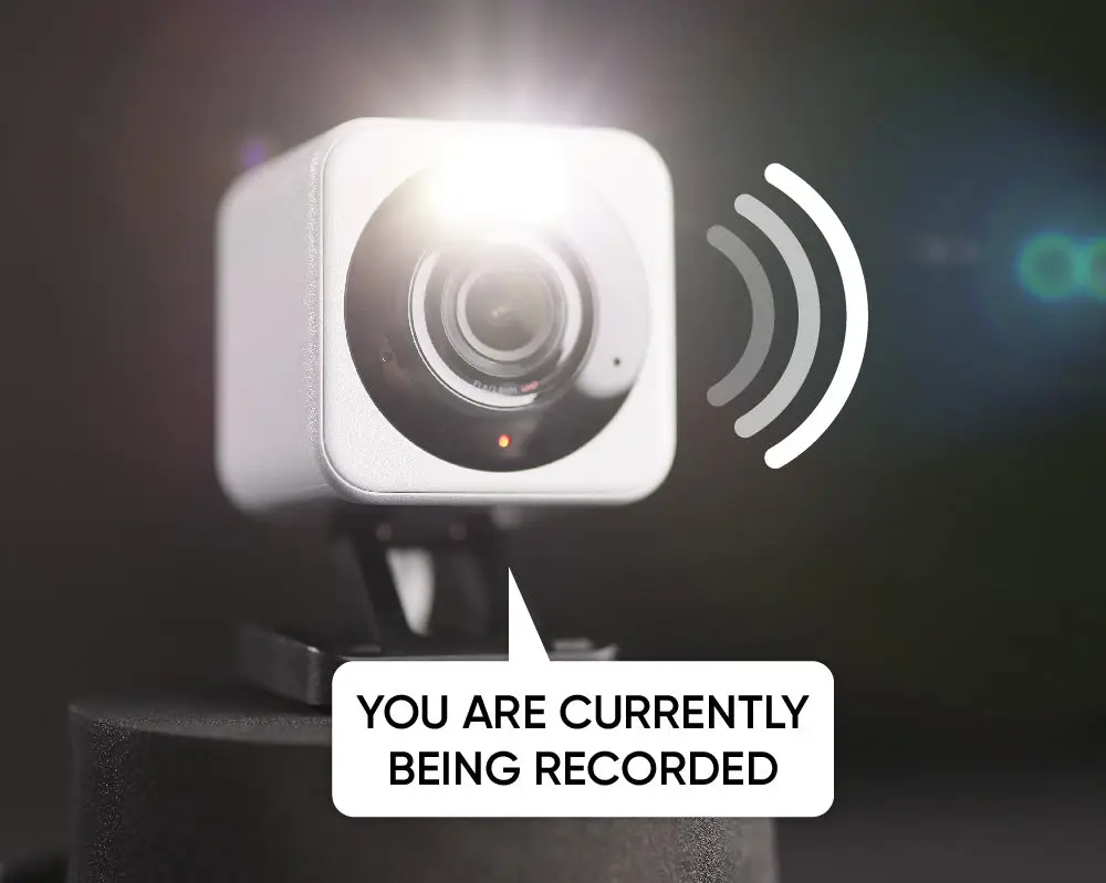 Wyze Cam v4 with its spotlight on and a speech bubble about recording