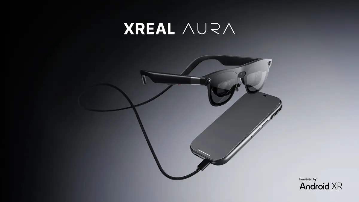 XREAL AURA glasses floating above a compute puck, joined by a cable